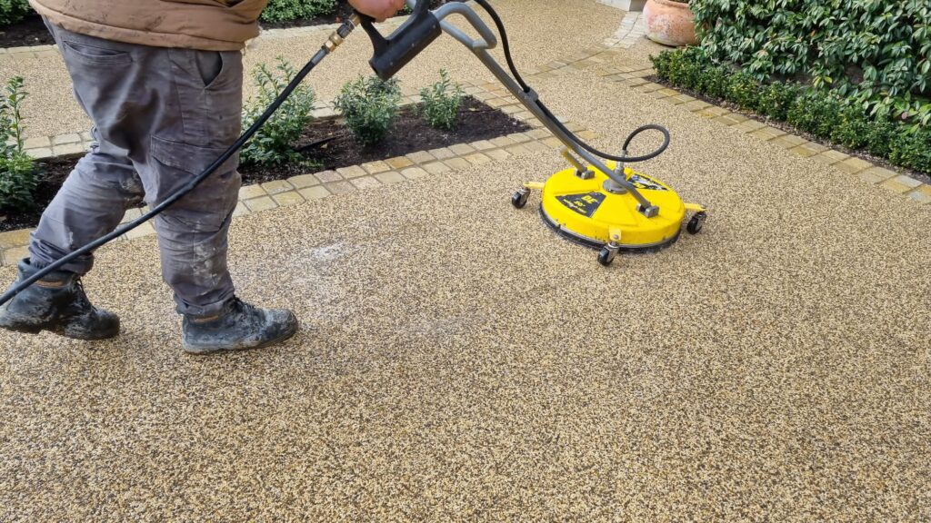 Professional team cleaning a resin-bound school yard in London.