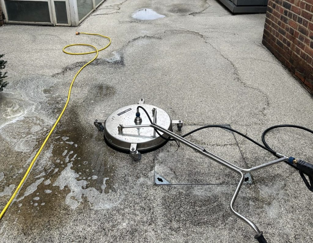 Professional team cleaning a resin-bound school yard in London.