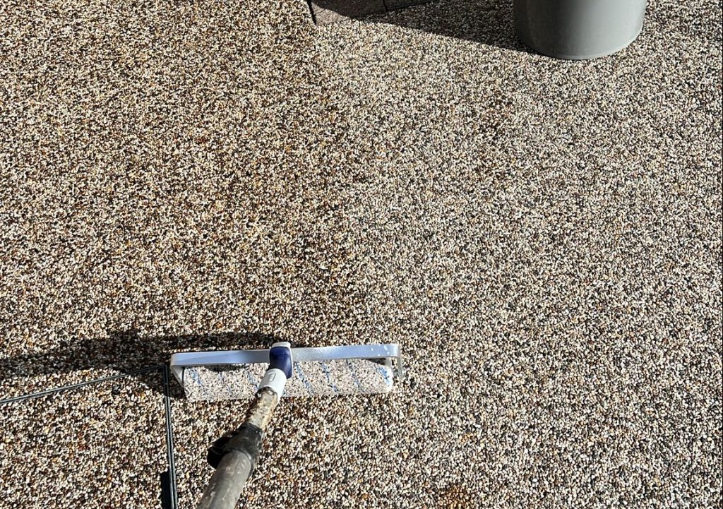 Technician applying a premium sealant on a resin surface